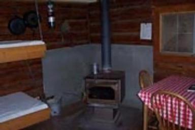 Wood burning stove and dining table inside the cabin