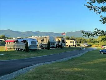 Row of RV sites with mountain panorama on a sunny summer day