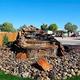 Large rock waterfall feature surrounded by river stones at USA RV Park in Gallup, New Mexico.