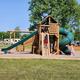 Playground structure with campground in background, demonstrating on-site family amenities and nearby RV sites — from the property’s Gallery page images.