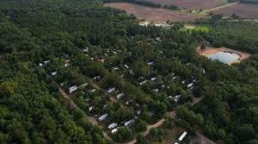 Aerial view showing the campground footprint and surrounding forest; useful alternate wide overview emphasizing site density and context (source: Seasonal Site Information).
