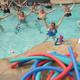 Pool activity (water aerobics) in a resort-style swimming pool — useful to show aquatic facilities available at the property; appears on the facility photo gallery.