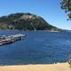 Marina view with docked boats, sandy beach and mountain backdrop — good overview of marina and beach area shown on the marina/fishing page.