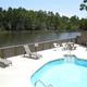 Pool and clubhouse deck overlooking the water — shows guest amenities and scenic view from central facilities (Clubhouse View Overlooking Water).