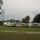 Another view of RV lots and grassy areas with hookups visible; useful for showing the camping area and site variety as presented on the park website.