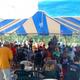 Large tent/pavilion event photo with many campers seated — depicts the campground’s event/assembly space and seasonal community activities (from Seasonal Camping page).