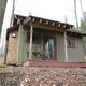 Front view of the Bella Donna cabin — clear, framed exterior photo useful to show specific cabin unit and porch amenity on the property (from cabin rental page).