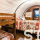 Interior shot showing bedding and bunks inside a wagon/yurt — useful to show accommodation interiors and sleeping layout (labeled Stay image on homepage).