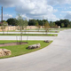 Shows multiple concrete RV pads, landscaped islands and open lanes — a view of the site’s lot design; image appears on the property site as an amenities/background image.