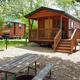Photo of cabins with picnic table and gravel pad — clear depiction of rental cabin accommodations on the property (file shown in site’s cabin/gallery).