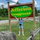 Girl presenting campground sign