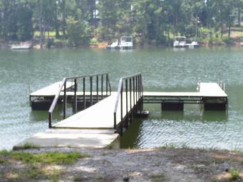 Small courtesy dock on the water—depicts on-site access to the lake and typical dock facilities for visitors.