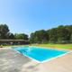 Outdoor swimming pool with surrounding lawn and fence — highlights on-site recreation facility. Source page: 'Pool.jpeg' on homepage.