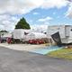 Wide view of multiple RV sites and paved drive aisles with palm trees — useful overview of typical RV pads at Barrington Hills as shown in the resort photo set on the page.