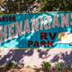 Large, distinctive entrance sign reading 'Shenanigans RV Park' — good hero shot establishing property identity; comes from the park homepage.