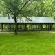 Large covered pavilion structure on grassy area within the campground — useful facility photo (from Campground Rentals page).