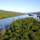 Aerial/drone view showing the lake, wooded campground shoreline and docks — good overall site overview and context for the property.