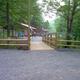 Entry bridge and path leading toward the pool/building area — provides context for the site layout and access on the property (Pool page).
