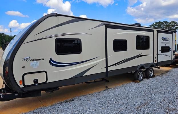 Large RV with outdoor kitchen, fireplace, and TVs