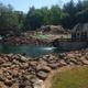 Miniature golf course and water feature with rock landscaping — shows the park’s miniature golf attraction and on-site recreational facilities (from the Amenities page).