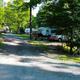Roadway view showing multiple parked RVs along a wooded drive — good overview of RV sites and campsite layout, from the campground's 'ways to stay' images.