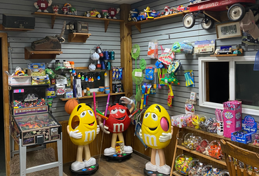 Interior of a camp store with candy, toys and merchandise — shows the on-site store facilities and visitor services.
