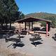 Cedro Peak Robin Campsite Pavilion with multiple picnic tables and grills