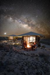 Luxury safari tent with a private deck, campfire, and views of the Milky Way for private stargazing at Camp Elena in Terlingua, Texas, near Big Bend National Park.