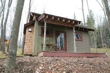 Front view of the Bella Donna cabin — clear, framed exterior photo useful to show specific cabin unit and porch amenity on the property (from cabin rental page).