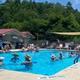Outdoor swimming pool with on-site buildings and seating visible — depicts a key guest facility and atmosphere (page: Starlite Lodge).