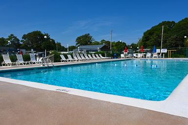 On-site swimming pool photo showing pool deck, lounge chairs and amenities — demonstrates guest recreation facilities.
