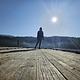 A  person stands silhouetted at the end of the dock at South Skookum Lake Campground. 