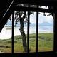 View of ocean and mountains outside Mallard Slough Cabin window