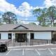 Exterior view of the clubhouse building (main amenity building) and parking — useful to show facilities available to guests.