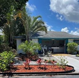 Image of the office/clubhouse exterior with landscaping and covered entry — useful for showing the park's facilities and guest services area (Home page).