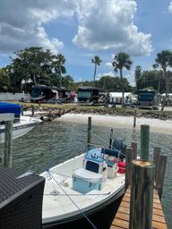 View from the water/dock showing boats and RVs lined along the shore — emphasizes marina access and RV slips, reinforcing on-site boat docking (from RV park/gallery pages).