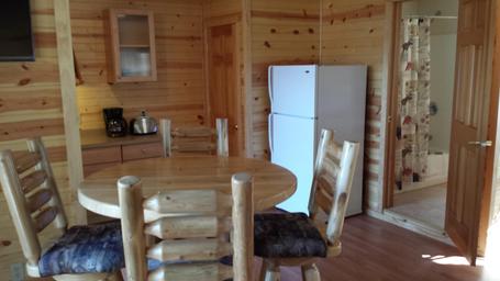 Dining area and kitchenette inside a cabin/rental — from the Rentals page, useful to illustrate interior features of campground rentals.
