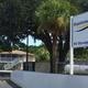 Entrance sign and front property view showing park name, office building and propane tanks — useful arrival/entrance photo (visible on site header).