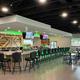 Interior shot of the Bar & Grill (bar seating and tables) — matches page context stating the on‑site restaurant and shows a facility guests can use.