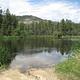 HORSETHIEF reservoir nestled in the trees with small rocky beach