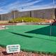 Small putting/green area with signage and surrounding landscaping — a campsite amenity shown on the resort page.