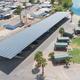 Aerial view showing the large covered RV storage canopy, nearby cabins and the Colorado River inlet — useful overall property/layout photo (from the RV/boat storage page).