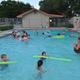Swimming pool in use with surrounding pool facilities — illustrates the campground's pool amenity (matches recreation/gallery photos on the site).