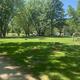Playground area adjacent to gravel roadway and grassy campsites — useful facility photo appearing on the property’s photo gallery page.