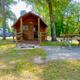 Small standalone cabin with porch and picnic table in a wooded setting — represents rental cabin accommodations on the property (source: site homepage).