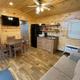 Interior view of a cabin living area/kitchen showing furnishings and finishes — supports the cabins listing and gives guests a clear sense of interior accommodations.