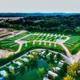 Aerial/drone overview showing RV pads, road layout and ponds — clear property-wide view useful as an overview. Image appears on the homepage (social image) confirming it depicts the campground.