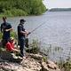 Three men fishing from shoreline.