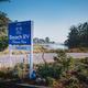 Beach RV Pleasure Point entrance sign and garden, with the lagoon across the road.