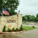 A stone wall with a sign that says oklahoma rv park